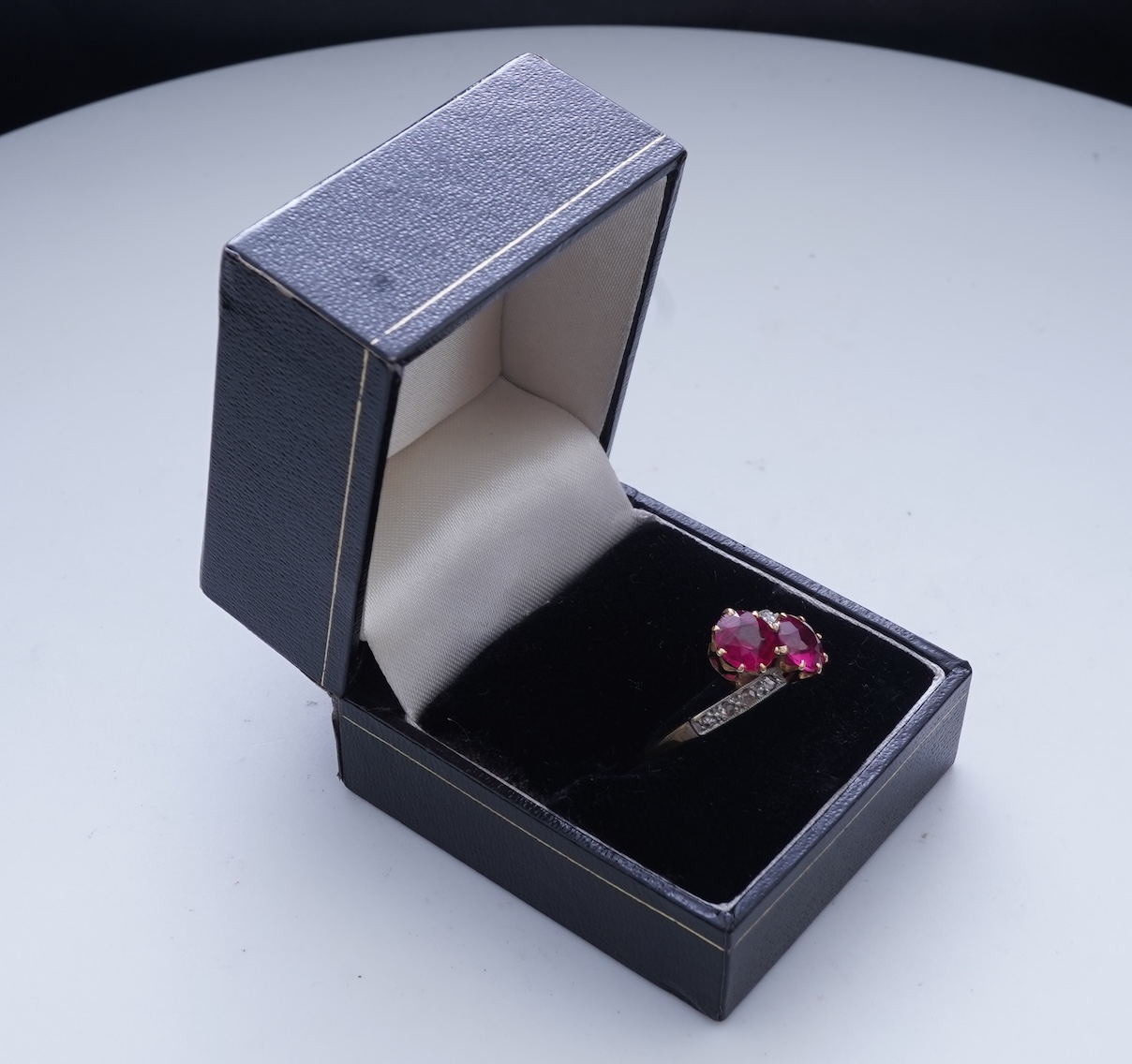 A synthetic ruby and diamond 'toi-et-moi' ring, early 20th century